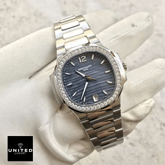 Patek Philippe Nautilus Ladies 7018/1A Replica 4 Patek Philippe Diamond Bezel Blue Dial Steel Bracelet Replica on the white glove hand