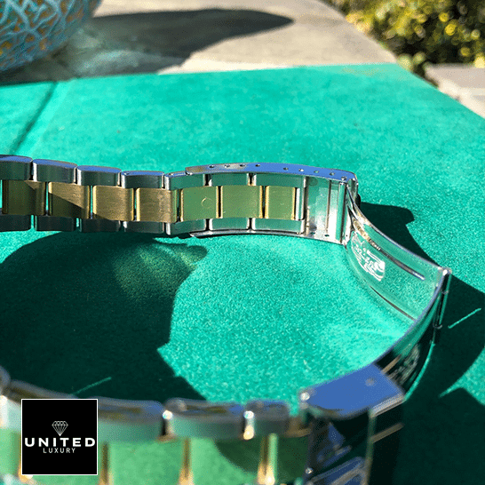 Rolex Submariner Serti Two Tone Stainless Steel Gold Diamond 16613 Replica 12 Rolex Submariner 16613 Two Tone Stainless Steel Gold Diamond Replica on the table