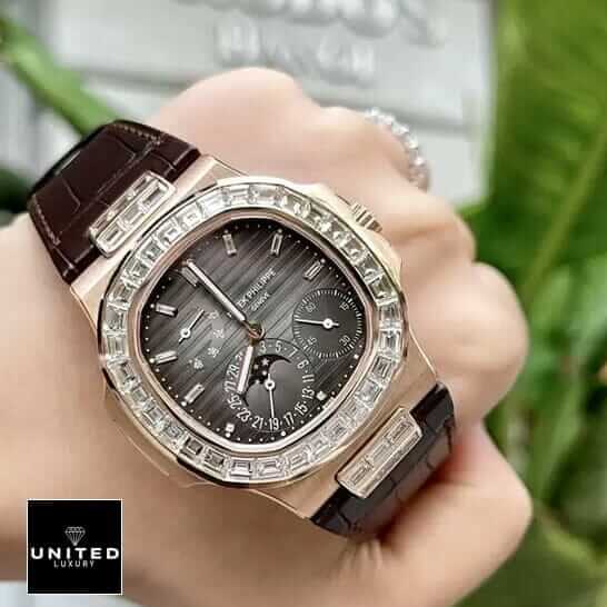 Patek Philippe Baguette Replica 3 Patek Philippe Gold Case Diamond Bezel Black Dial Replica on thhe hand